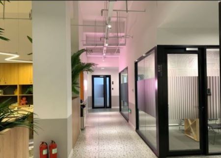 Office corridor leading to glass meeting rooms